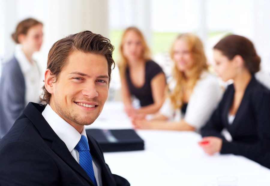 man sitting with colleagues